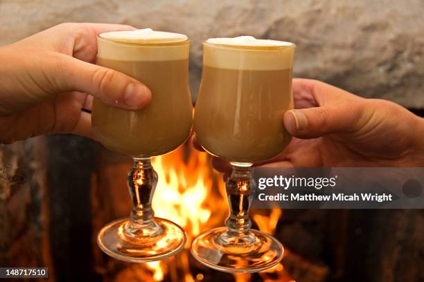 irish coffee by fireside. - irish coffee stock-fotos und bilder