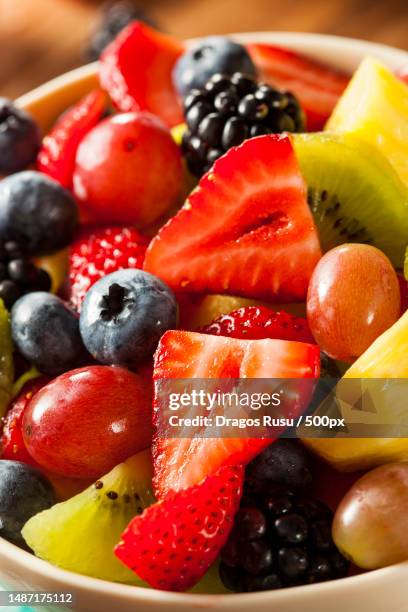 heallthy organic fruit salad with berries pineapple and grapes,romania - salade de fruits photos et images de collection
