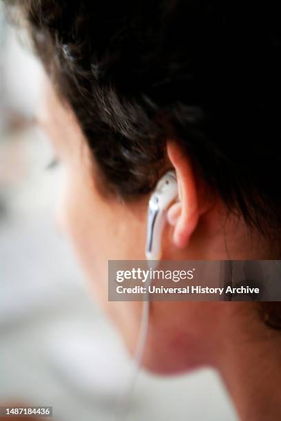 Young woman with auricolar