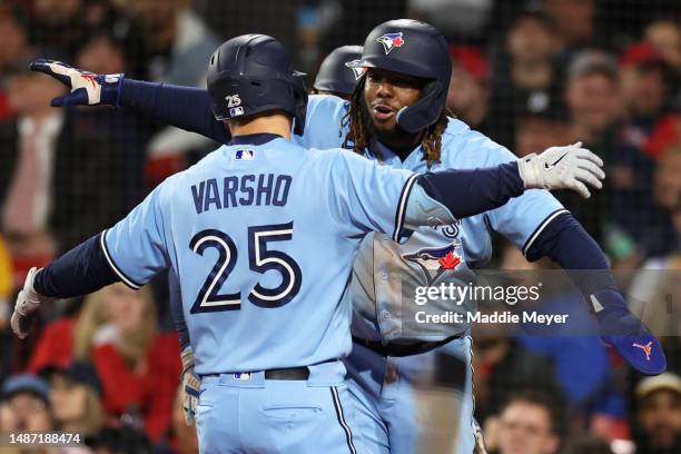 Daulton Varsho of the Toronto Blue Jays celebrates with Vladimir Guerrero Jr. #27 after hitting a three run home run against the Boston Red Sox...