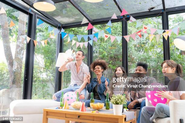 group of young people having a party at home - anticipation excited stock pictures, royalty-free photos & images