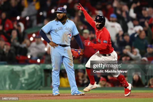 Connor Wong of the Boston Red Sox celebrates in front of Vladimir Guerrero Jr. #27 of the Toronto Blue Jays after hitting a home run during the sixth...