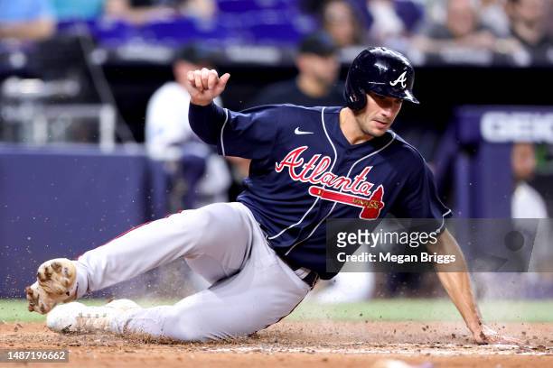 Matt Olson of the Atlanta Braves slides home to score a run against the Miami Marlins during the fifth inning at loanDepot park on May 02, 2023 in...
