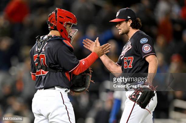 Kyle Finnegan of the Washington Nationals celebrates with Keibert Ruiz after a 4-1 victory against the Chicago Cubs at Nationals Park on May 02, 2023...