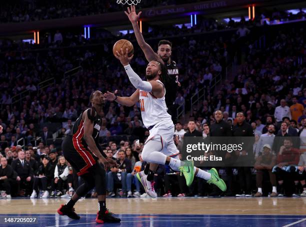 Jalen Brunson of the New York Knicks heads for the net as Bam Adebayo and Max Strus of the Miami Heat defend in the fourth quarter during game two of...