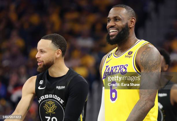 Stephen Curry of the Golden State Warriors and LeBron James of the Los Angeles Lakers react during the first quarter in game one of the Western...