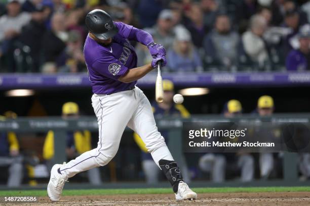 Elias Diaz of the Colorado Rockies hits a RBI single against the Milwaukee Brewers in the eighth inning at Coors Field on May 02, 2023 in Denver,...