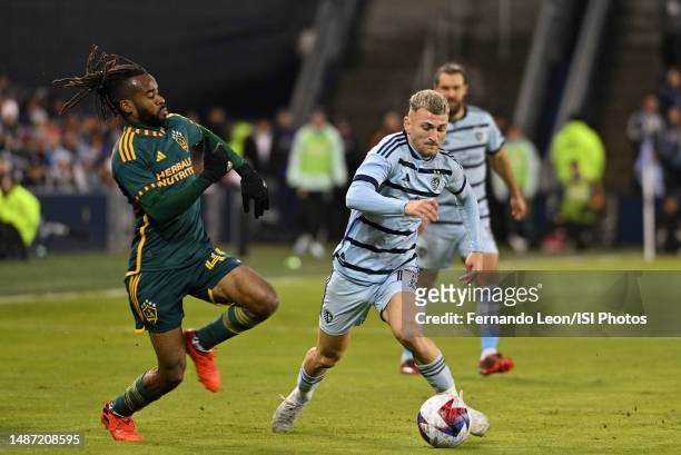 Raheem Edwards of Los Angeles Galaxy and Marinos Tzionis of Sporting Kansas City battle for possession of the ball during a game between Los Angeles...