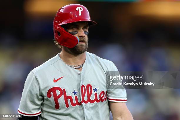 Bryce Harper of the Philadelphia Phillies looks on after striking out during the first inning against the Los Angeles Dodgers at Dodger Stadium on...