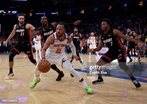 Jalen Brunson of the New York Knicks tries to avoid Max Strus,Bam Adebayo and Kyle Lowry of the Miami Heat in the final minutes of game two of the...