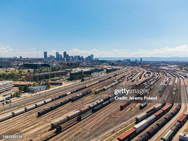 a high angle view of trains in a large railyard north of denver, colorado near "the mousetrap" highway interchange - denver summer stock pictures, royalty-free photos & images