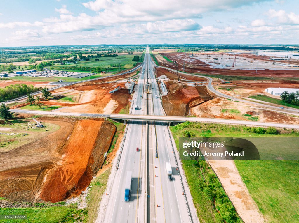 Aerial Photo of Semi Trucks Passing Red Dirt Work and Construction at the Interstate 65 Exit for Glendale, Kentucky, USA