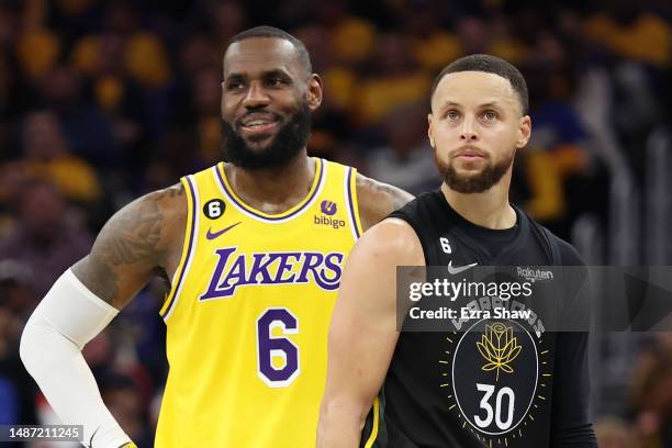 LeBron James of the Los Angeles Lakers stands next to Stephen Curry of the Golden State Warriors during the second quarter in game one of the Western...