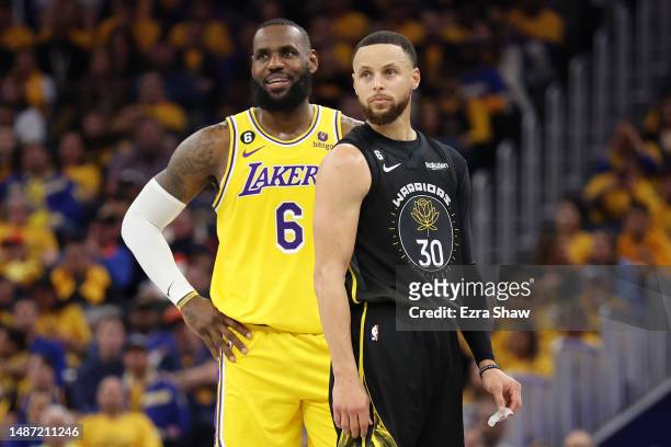 LeBron James of the Los Angeles Lakers stands next to Stephen Curry of the Golden State Warriors during the second quarter in game one of the Western...