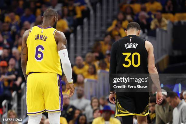 LeBron James of the Los Angeles Lakers stands next to Stephen Curry of the Golden State Warriors during the second quarter in game one of the Western...