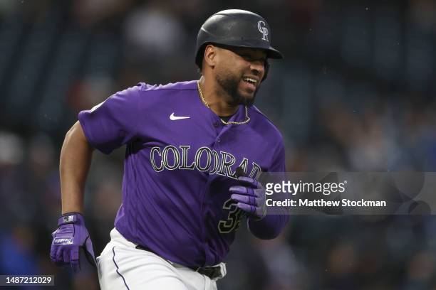 Elias Diaz of the Colorado Rockies circles the bases after hitting a solo home run against the Milwaukee Brewers in the fourth inning at Coors Field...