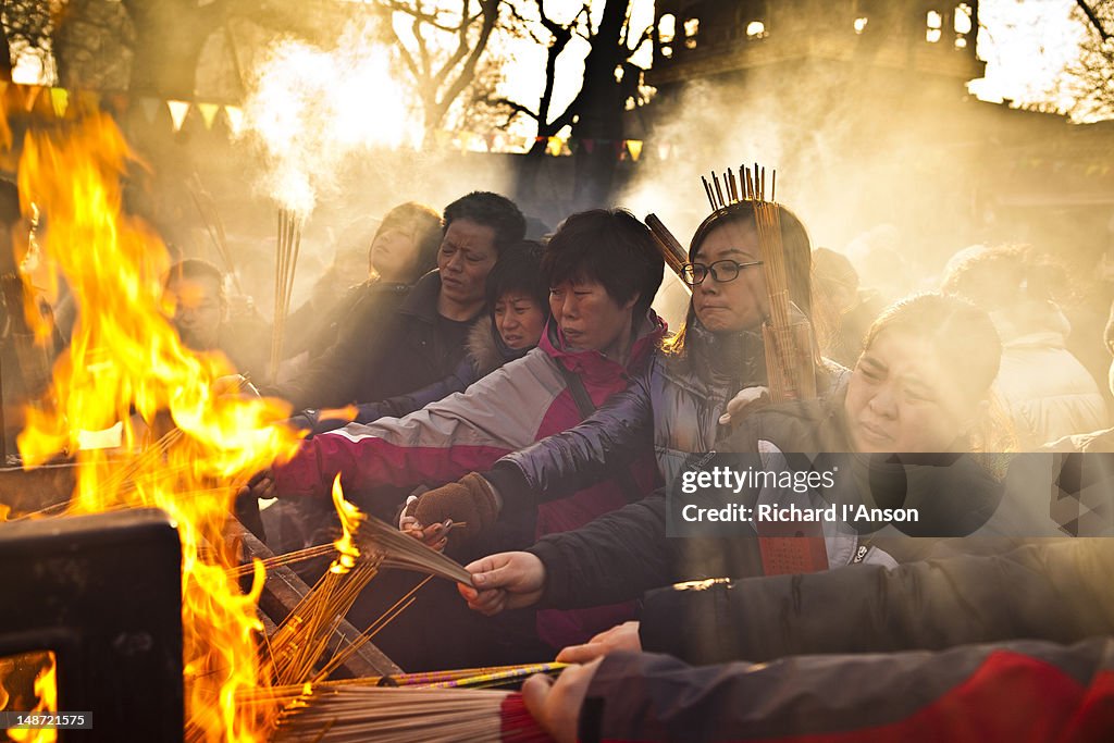 Worshippers burning incense at Lama Temple on Chinese New Year day.