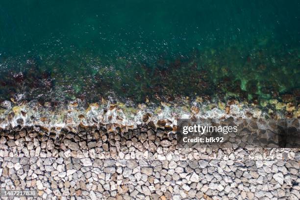 aerial view of black sea waves and protection concrete barriers in the sea. - stödjemur bildbanksfoton och bilder