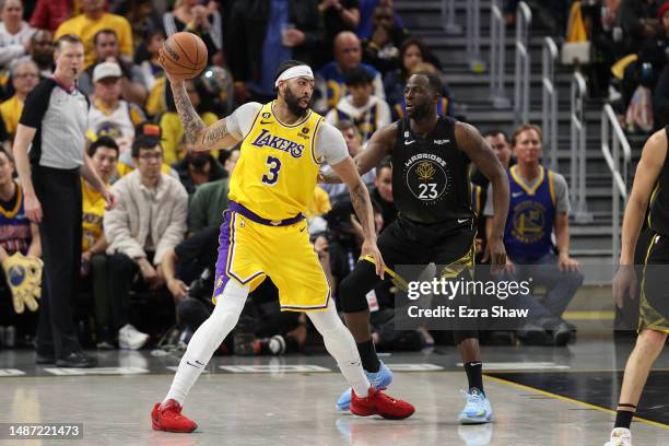 Anthony Davis of the Los Angeles Lakers handles the ball against Draymond Green of the Golden State Warriors during the fourth quarter in game one of...