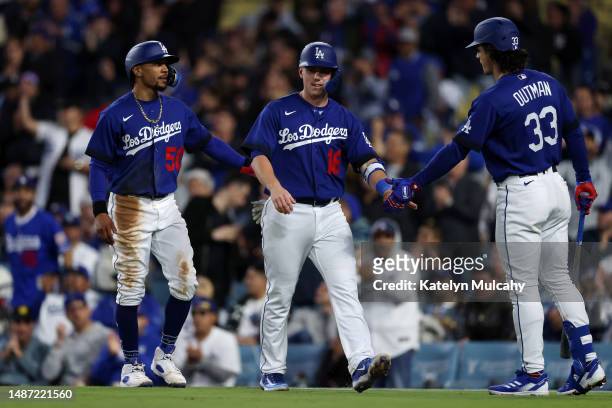 Mookie Betts, Will Smith and James Outman of the Los Angeles Dodgers celebrate runs scored in during the seventh inning against the Philadelphia...