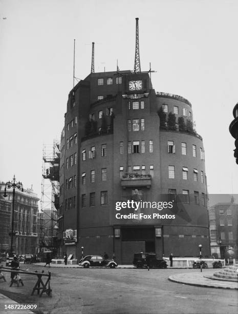 Exterior view of Broadcasting House, the headquarters of the BBC, clad in camouflage to avoid detection during World War Two, on Langham Place in the...