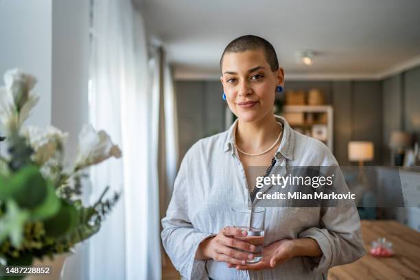 young beautiful woman drinks water during class, dehydration - casual headshot stock pictures, royalty-free photos & images