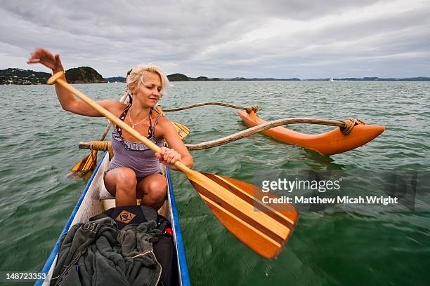 a cultural activity, outrigger canoeing is a popular past-time here in the bay of islands. paddeling on a waka with a maori guide is a great way to see the islands - bay of islands stock pictures, royalty-free photos & images