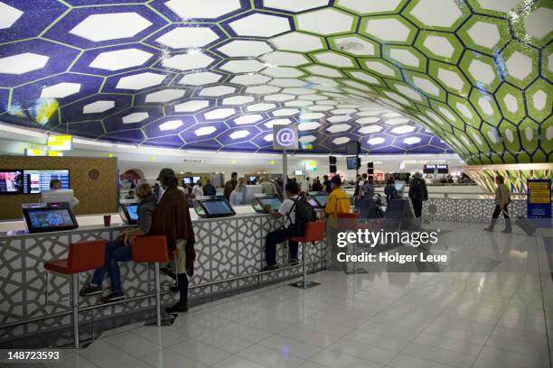 passengers using internet terminals at abu dhabi international airport. - abu dhabi airport bildbanksfoton och bilder