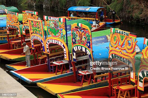 trajineras boats at floating gardens of xochimilco. - trajinera stock pictures, royalty-free photos & images