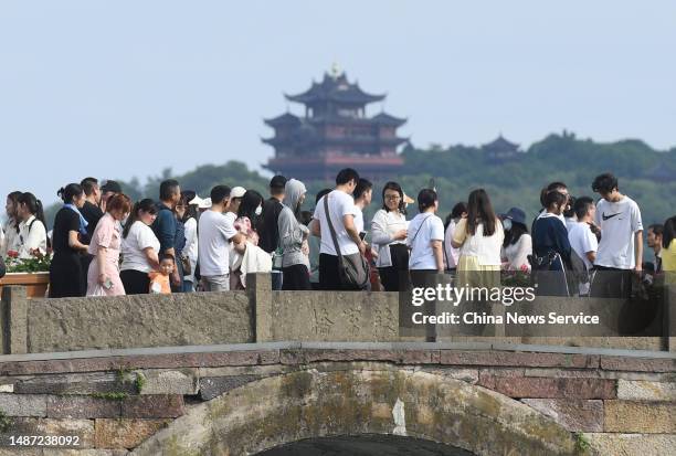 Tourists visit West Lake scenic area during the May Day holiday on May 2, 2023 in Hangzhou, Zhejiang Province of China.