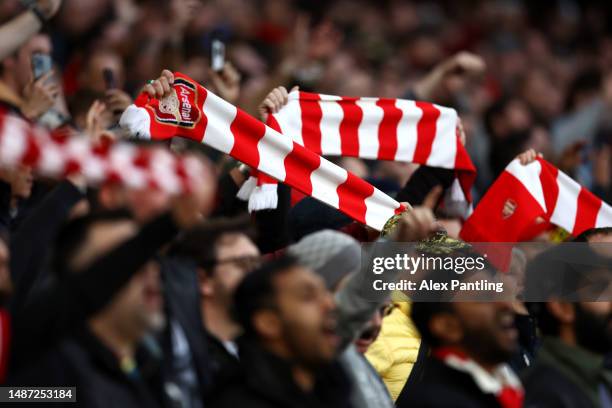 Arsenal fans raise their scarfs during the Premier League match between Arsenal FC and Chelsea FC at Emirates Stadium on May 02, 2023 in London,...