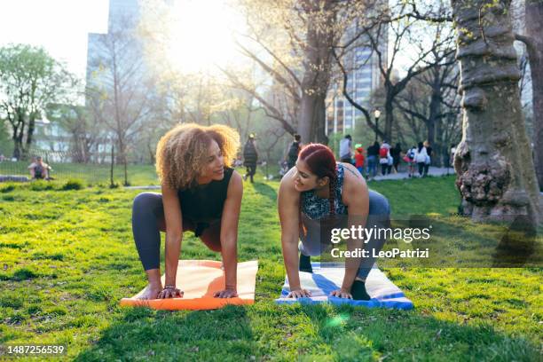 yoga personal training in central park - yoga day stock pictures, royalty-free photos & images