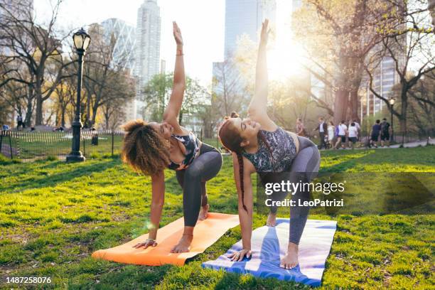 yoga personal training in central park - central park manhattan stock pictures, royalty-free photos & images