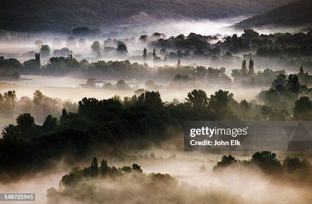 mist over countryside. - paysage france foret photos et images de collection