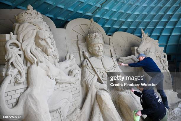 Sculptor and director of Weymouth's SandWorld Sculpture Park, Mark Anderson and sculptor and Annette Rydin with their King Charles III sand sculpture...