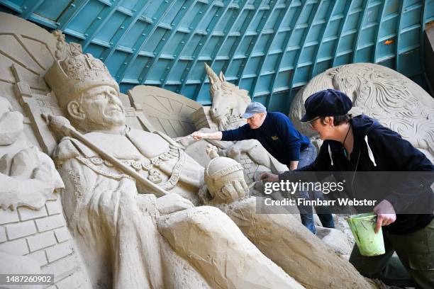 Sculptor and director of Weymouth's SandWorld Sculpture Park, Mark Anderson and sculptor and Annette Rydin with their King Charles III sand sculpture...