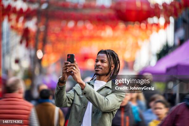 man taking photo of chinese lanterns in soho, london - county_fair stock pictures, royalty-free photos & images