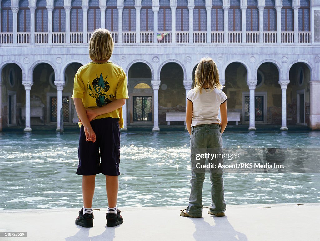 Children looking over canal.
