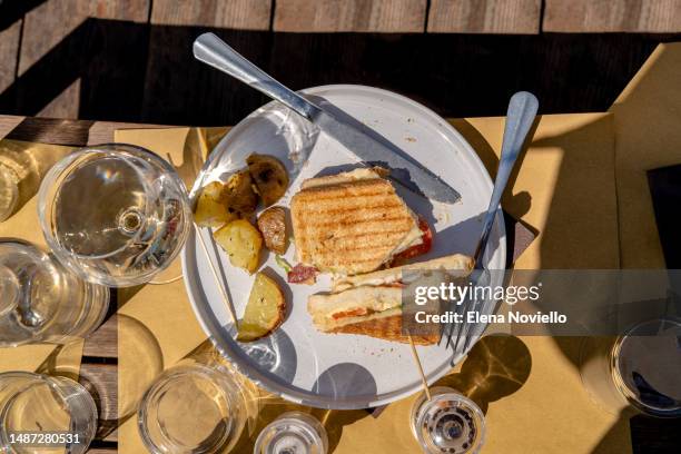 woman eating a salmon and vegetable sandwich for lunch outdoors - sanduíche club - fotografias e filmes do acervo