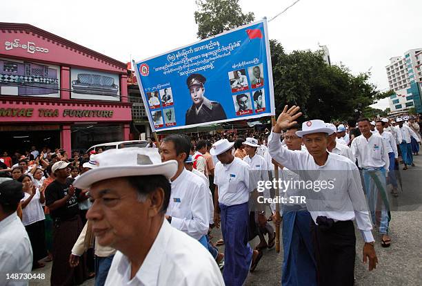 Myanmar people take part in a parade in honour of independence hero General Aung San, during a ceremony to mark the country's 65th anniversary of...