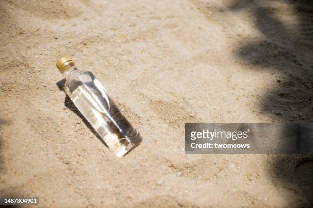 one drinking bottle on sand background. - cold drink beach stock pictures, royalty-free photos & images