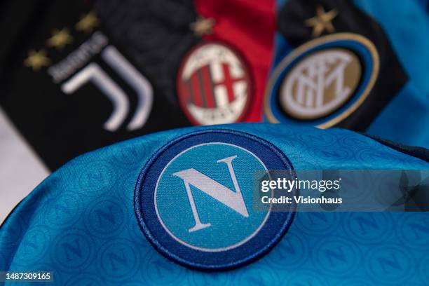 The official SSC Napoli FC club badge on a home shirt with the badges of Juventus, AC Milan and Inter Milan on May 3, 2023 in Manchester, United...