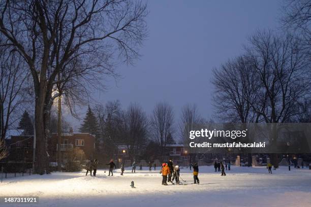 playing hockey in a public park in montreal - ice rink stock pictures, royalty-free photos & images
