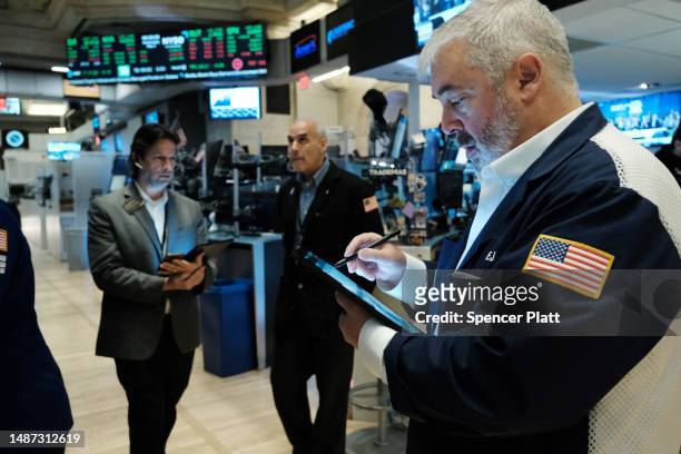 Traders work on the floor of the New York Stock Exchange on May 03, 2023 in New York City. The Dow was slightly lower in morning trading as investors...
