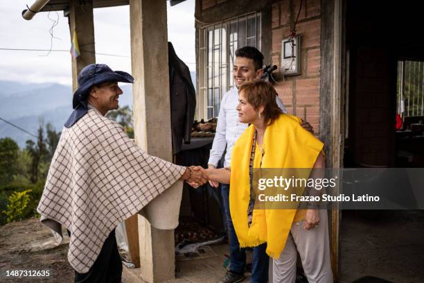 farmers greeting in front of the house - traditional colombian clothing stock pictures, royalty-free photos & images