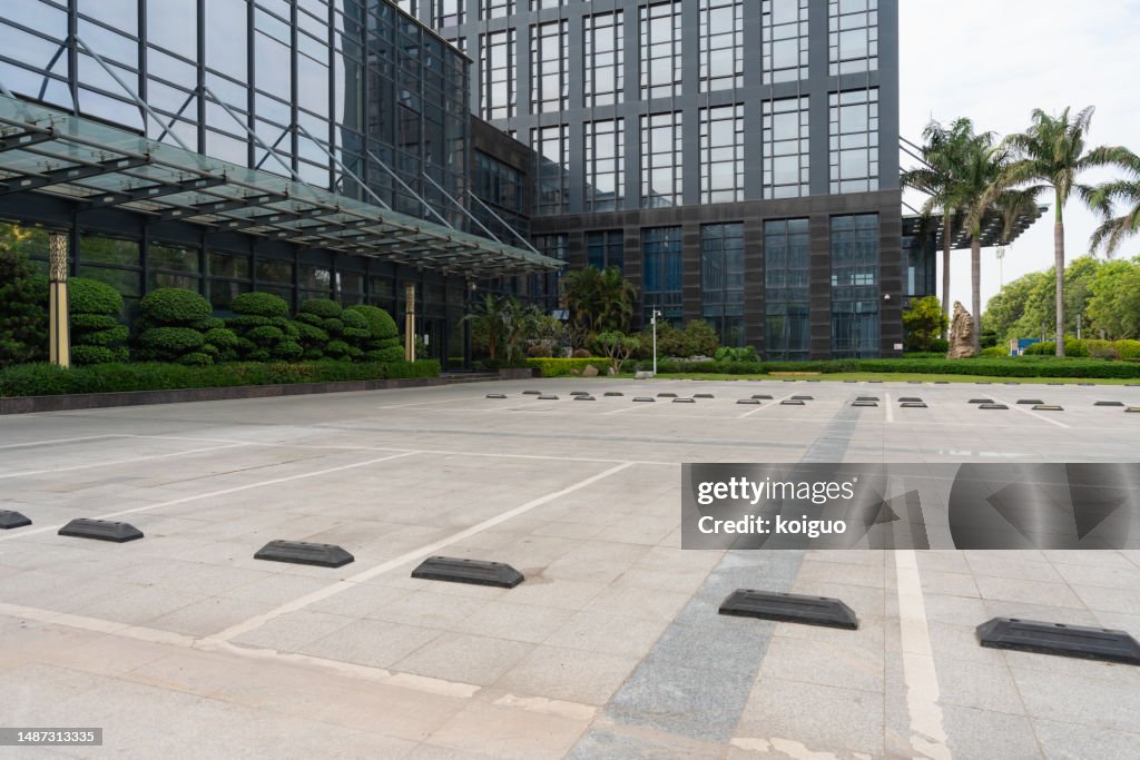Empty parking lot in front of office building