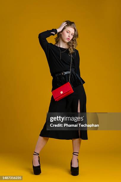 fashionable woman in black dress - crossbody bag stock pictures, royalty-free photos & images