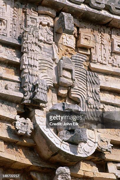 a chac mask carved in stone on an external wall of the governor's palace(palacio del gobernador) on the mayan site at uxmal. - palacio del gobernador stock pictures, royalty-free photos & images