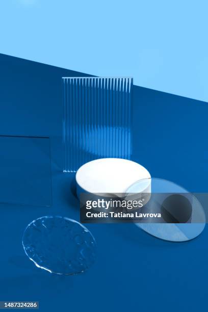 many different geometric shapes on blue background. nice backdrop for beauty products presentation. white podium. front view, high angle shot - 3d chart stock pictures, royalty-free photos & images