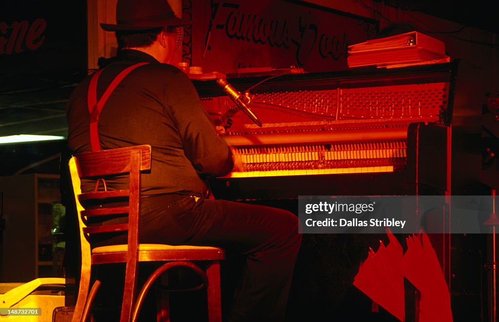 Red hot jazz pianist entertains the crowd on Bourbon Street in New Orleans.